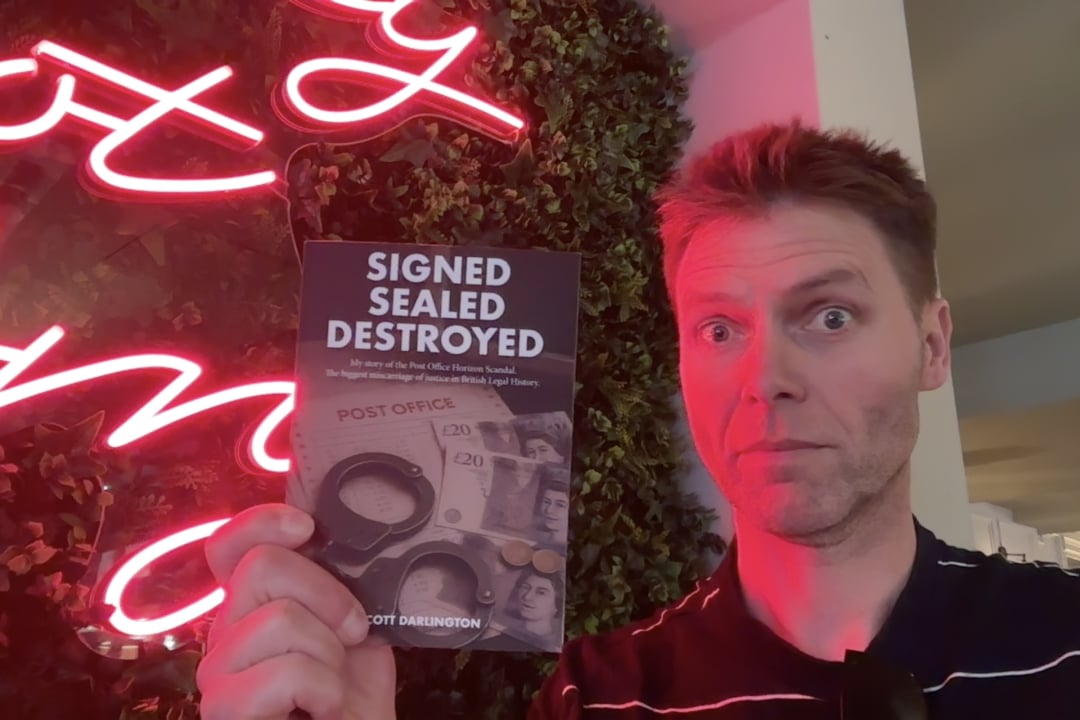 Nick Wallis with a less red version of Signed Sealed Destroyed and the neon sign behind me which made it red in the above photo